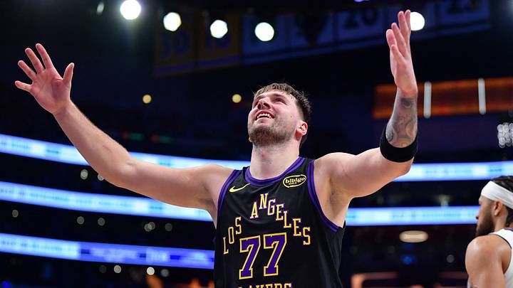 Dec 30, 2025; Los Angeles, California, USA; Los Angeles Lakers guard Luka Doncic (77) reacts after scoring a basket against the Detroit Pistons during the second half at Crypto.com Arena. Mandatory Credit: Gary A. Vasquez-Imagn Images