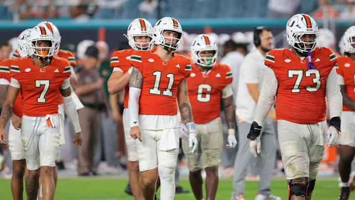 Sep 20, 2025; Miami Gardens, Florida, USA; Miami Hurricanes quarterback Carson Beck (11) and his teammates walk toward the line of scrimmage against the Florida Gators during the fourth quarter at Hard Rock Stadium. Mandatory Credit: Sam Navarro-Imagn Images Sep 20, 2025; Miami Gardens, Florida, USA; Miami Hurricanes quarterback Carson Beck (11) and his teammates walk toward the line of scrimmage against the Florida Gators during the fourth quarter at Hard Rock Stadium. Mandatory Credit: Sam Navarro-Imagn Images