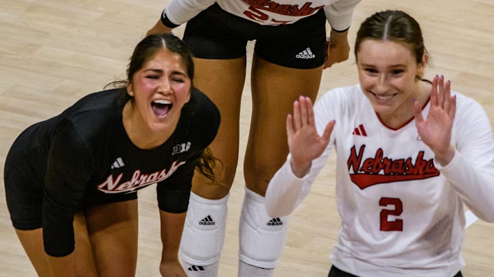 Lexi Rodriguez (left), Harper Murray (middle) and Bergan Reilly celebrate a kill from Rebekah Allick.  