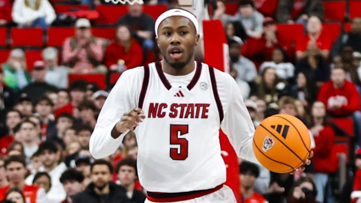 Jan 27, 2026; Raleigh, North Carolina, USA; NC State Wolfpack guard Tre Holloman (5) dribbles with the ball down the court during the first half of the game against the Syracuse Orange at Lenovo Center. Mandatory Credit: Jaylynn Nash-Imagn Images