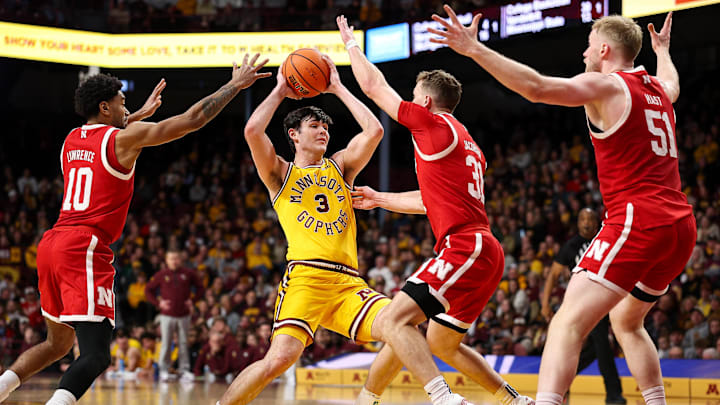 Minnesota Golden Gophers forward Bobby Durkin drives toward the basket as Nebraska Cornhuskers guards Jamarques Lawrence and Cale Jacobsen defend during the first half.