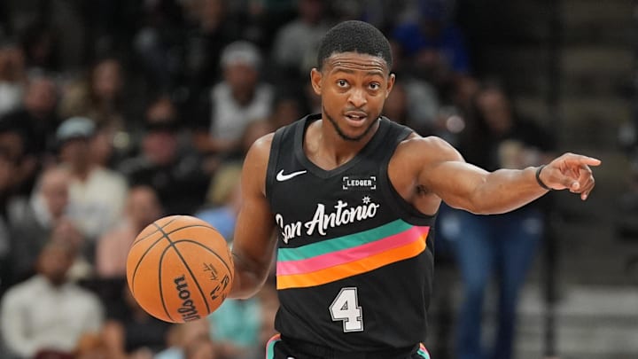 Nov 12, 2025; San Antonio, Texas, USA; San Antonio Spurs guard De'Aaron Fox (4) directs a play in the first half against the Golden State Warriors at Frost Bank Center.