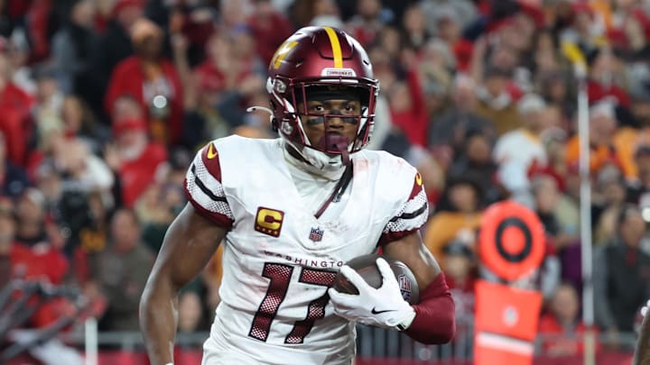 Jan 12, 2025; Tampa, Florida, USA; Washington Commanders wide receiver Terry McLaurin (17) reacts after catching a touchdown against Tampa Bay Buccaneers safety Josh Hayes (32) during the fourth quarter of a NFC wild card playoff at Raymond James Stadium. Mandatory Credit: Kim Klement Neitzel-Imagn Images