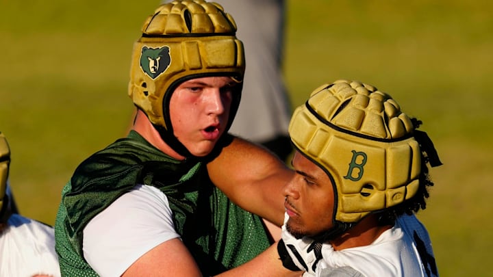 Basha tackle Jake Hildebrand battles edge rusher Darian “Bleu” Dantzler during a practice at Basha High School