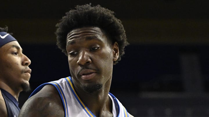 Nov 22, 2024; Los Angeles, California, USA; UCLA Bruins guard Eric Dailey Jr. (3) dribbles to the basket as Cal State Fullerton Titans guard Freddie Cooper (2) defends during the second half at Pauley Pavilion presented by Wescom. Mandatory Credit: Robert Hanashiro-Imagn Images