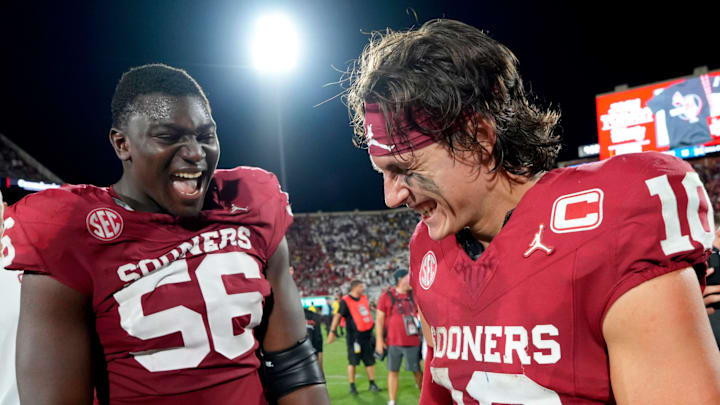 Oklahoma quarterback John Mateer (10) and offensive lineman Michael Fasusi