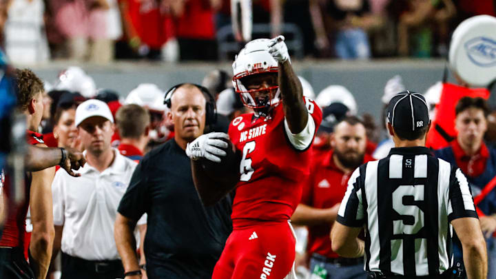 Aug 29, 2024; Raleigh, North Carolina, USA;  North Carolina State Wolfpack wide receiver Wesley Grimes (6) celebrates near the bench during the first half of the game against Western Carolina Catamounts at Carter-Finley Stadium. Mandatory Credit: Jaylynn Nash-Imagn Images