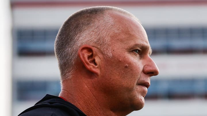 Aug 28, 2025; Raleigh, North Carolina, USA; North Carolina State Wolfpack head coach Dave Doeren looks on during the warmups prior to the game against East Carolina Pirates at Carter-Finley Stadium. Mandatory Credit: Jaylynn Nash-Imagn Images