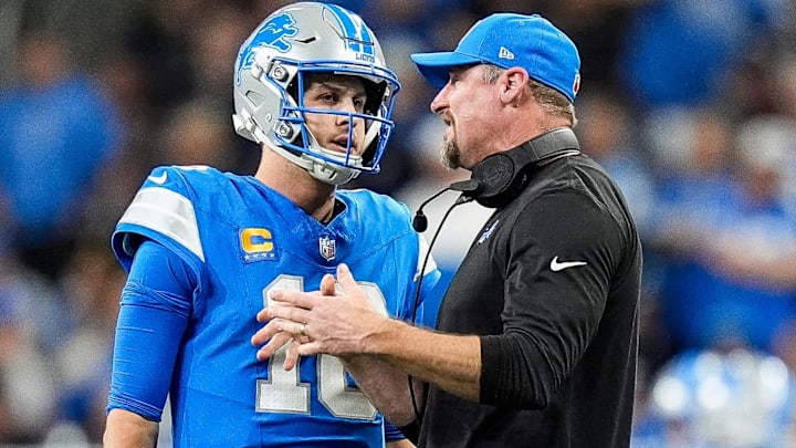 Detroit Lions quarterback Jared Goff (16) talks to head coach Dan Campbell before a play against the Green Bay Packers during the second half at Ford Field in Detroit on Thursday, Dec. 5, 2024.