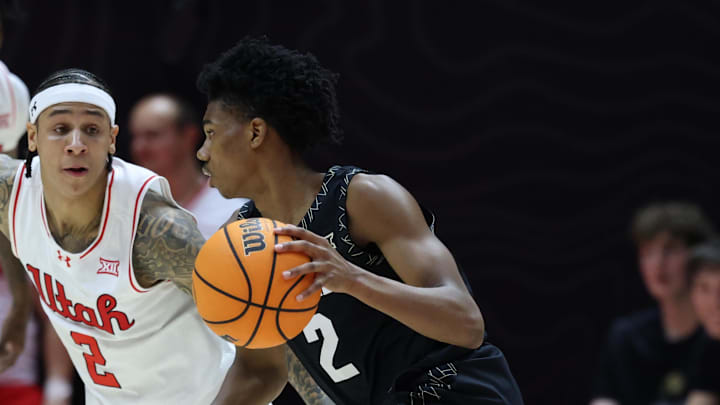 Colorado Buffaloes guard Isaiah Johnson (2) dribbles against Utah Utes guard Terrence Brown (2) during the second half at Jon M. Huntsman Center.