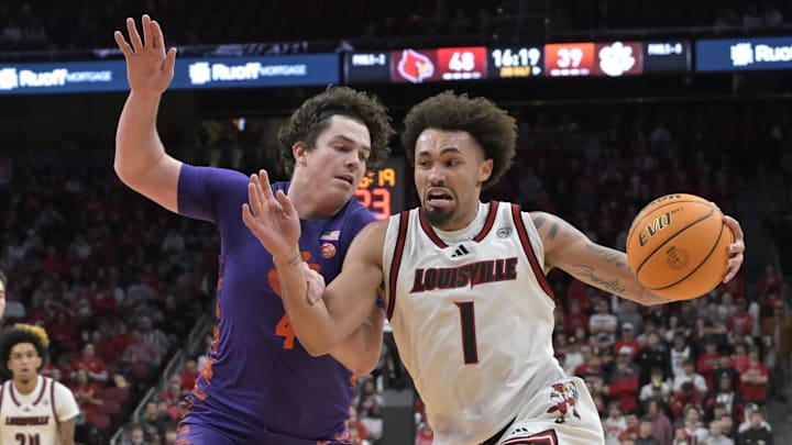 Jan 7, 2025; Louisville, Kentucky, USA; Louisville Cardinals guard J'Vonne Hadley (1) drives to the basket against Clemson Tigers forward Ian Schieffelin (4) during the second half at KFC Yum! Center. Louisville defeated Clemson 74-64. 
