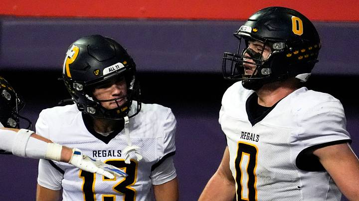 Iowa City Regina’s Tate Wallace (0) celebrates with teammates after scoring a touchdown Nov. 20, 2025 during the Class 1A state football championship against the West Lyon Wildcats at the UNI-Dome in Cedar Falls, Iowa. Iowa City Regina’s Tate Wallace (0) celebrates with teammates after scoring a touchdown Nov. 20, 2025 during the Class 1A state football championship against the West Lyon Wildcats at the UNI-Dome in Cedar Falls, Iowa.