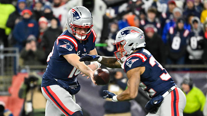 Jan 11, 2026; Foxborough, MA, USA; New England Patriots quarterback Drake Maye (10) hands the ball off to New England Patriots running back Treveyon Henderson (32) during the first quarter against the Los Angeles Chargers in an AFC Wild Card Round game at Gillette Stadium. Mandatory Credit: Eric Canha-Imagn Images