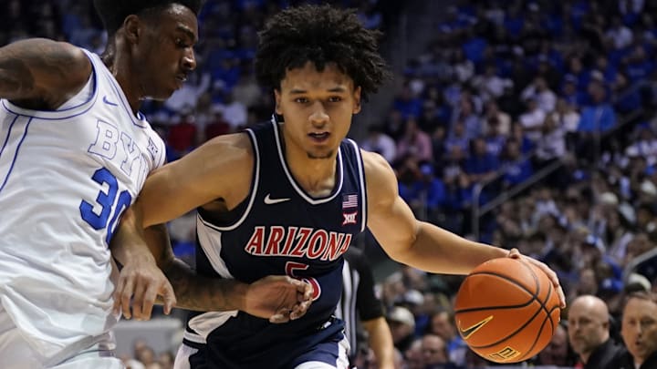 Jan 26, 2026; Provo, Utah, USA; Arizona Wildcats guard Brayden Burries (5) controls the ball while being defended by BYU Cougars forward Kennard Davis Jr. (30) during the second half at Marriott Center. Mandatory Credit: Aaron Baker-Imagn Images 