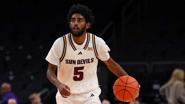 Dec 6, 2025; Phoenix, Arizona, USA; Arizona State University Sun Devils guard Moe Odum (5) dribbles down court against Oklahoma University Sooners forward Tae Davis (13) in the second half at PHX Arena. Mandatory Credit: Anna Carrington-Imagn Images