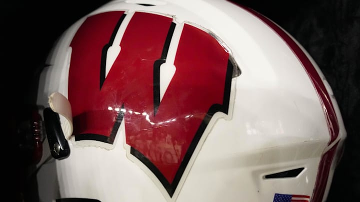 Aug 28, 2025; Madison, Wisconsin, USA; General view of a Wisconsin Badgers football helmet on the sidelines during the game against the Miami (OH) RedHawks at Camp Randall Stadium. Aug 28, 2025; Madison, Wisconsin, USA; General view of a Wisconsin Badgers football helmet on the sidelines during the game against the Miami (OH) RedHawks at Camp Randall Stadium.