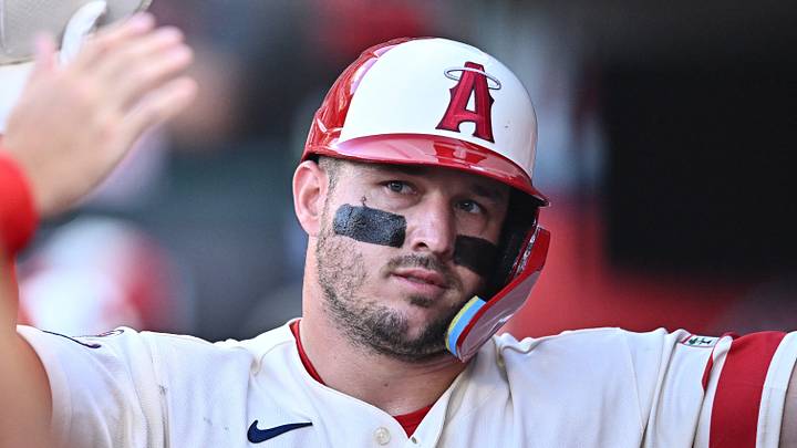 Anaheim, California, USA; Los Angeles Angels center fielder Mike Trout (27) is greeted by teammates after scoring during the first inning against the Houston Astros at Angel Stadium. Mandatory Credit: William Liang-Imagn Images