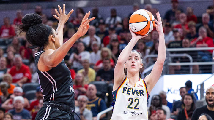Jul 9, 2025; Indianapolis, Indiana, USA; Indiana Fever guard Caitlin Clark (22) shoots the ball while Golden State Valkyries forward Monique Billings (25) defends in the first half at Gainbridge Fieldhouse. Mandatory Credit: Trevor Ruszkowski-Imagn Images