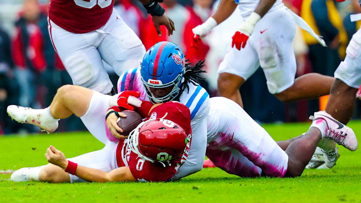 Ole Miss Rebels defensive end Princewill Umanmielen tackles Oklahoma Sooners quarterback John Mateer. Ole Miss Rebels defensive end Princewill Umanmielen tackles Oklahoma Sooners quarterback John Mateer.
