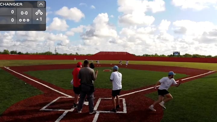 A screenshot shows coaches and players beginning to run for cover as shots rang out prior to a 12U baseball game at The Rac in Katy, Texas last Sunday morning.