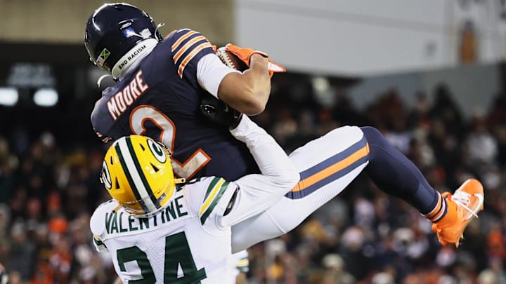 Chicago Bears wide receiver DJ Moore leaps to catch a pass thrown against Green Bay Packers cornerback Carrington Valentine.