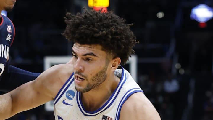 Mar 29, 2026; Washington, DC, USA; Duke Blue Devils forward Cameron Boozer (12) goes to the basket against UConn Huskies forward Jayden Ross (23) in the first half during an Elite Eight game of the East Regional of the men's 2026 NCAA Tournament at Capital One Arena. Mandatory Credit: Amber Searls-Imagn Images Mar 29, 2026; Washington, DC, USA; Duke Blue Devils forward Cameron Boozer (12) goes to the basket against UConn Huskies forward Jayden Ross (23) in the first half during an Elite Eight game of the East Regional of the men's 2026 NCAA Tournament at Capital One Arena. Mandatory Credit: Amber Searls-Imagn Images