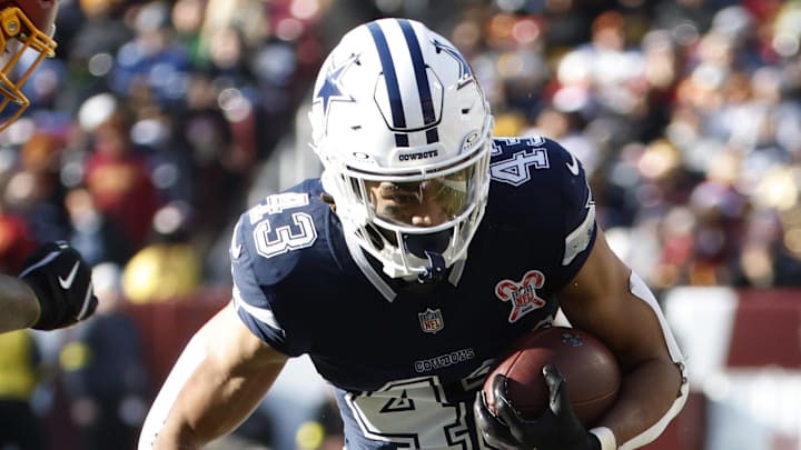 Dec 25, 2025; Landover, Maryland, USA; Dallas Cowboys running back Malik Davis (43) carries the ball as Washington Commanders linebacker Frankie Luvu (4) defends during the first half at Northwest Stadium.