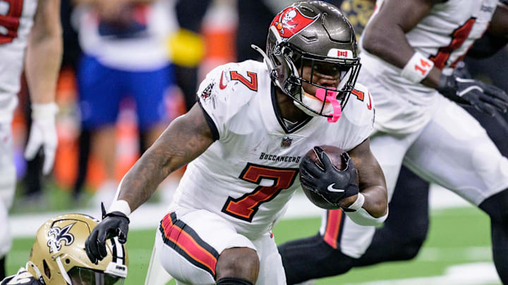 Oct 13, 2024; New Orleans, Louisiana, USA; New Orleans Saints defensive tackle Khalen Saunders (50) attempts to tackle Tampa Bay Buccaneers running back Bucky Irving (7) with a a piece from his shirt during the second quarter at Caesars Superdome. Mandatory Credit: Matthew Hinton-Imagn Images