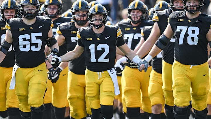 Oct 12, 2024; Iowa City, Iowa, USA; Iowa Hawkeyes quarterback Cade McNamara (12) leads the Iowa Swarm before the game against the Washington Huskies at Kinnick Stadium. Mandatory Credit: Jeffrey Becker-Imagn Images