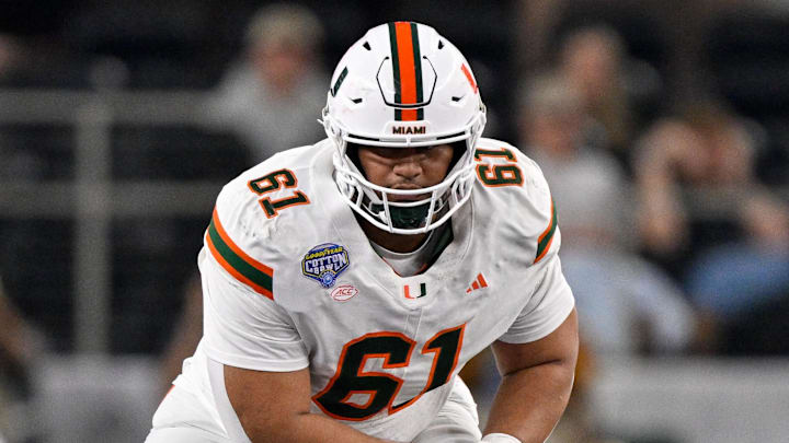 Dec 31, 2025; Arlington, TX, USA; Miami Hurricanes offensive lineman Francis Mauigoa (61) gets into position during the 2025 Cotton Bowl and quarterfinal game of the College Football Playoff at AT&T Stadium. Mandatory Credit: Jerome Miron-Imagn Images