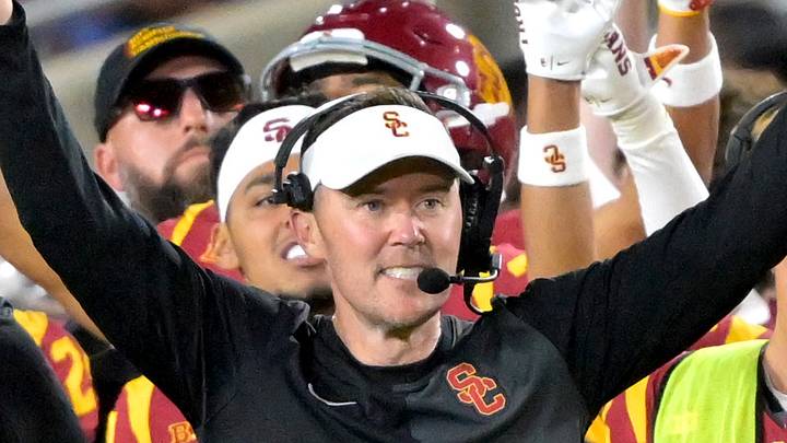 USC Trojans head coach Lincoln Riley and defensive line coach Shaun Nua celebrate on the sideline. USC Trojans head coach Lincoln Riley and defensive line coach Shaun Nua celebrate on the sideline.