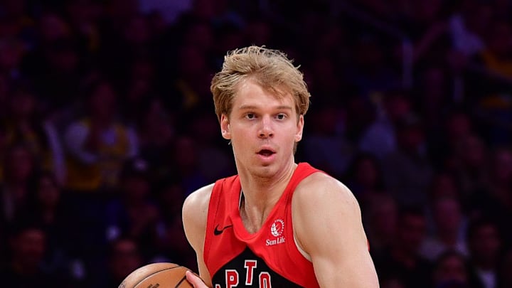 Toronto Raptors guard Gradey Dick moves the ball against Los Angeles Lakers guard Gabe Vincent.