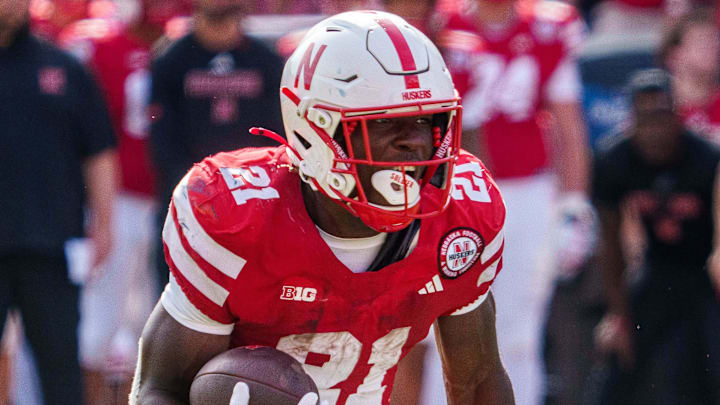 Sep 20, 2025; Lincoln, Nebraska, USA; Nebraska Cornhuskers running back Emmett Johnson (21) runs against the Michigan Wolverines during the second quarter at Memorial Stadium. Mandatory Credit: Dylan Widger-Imagn Images