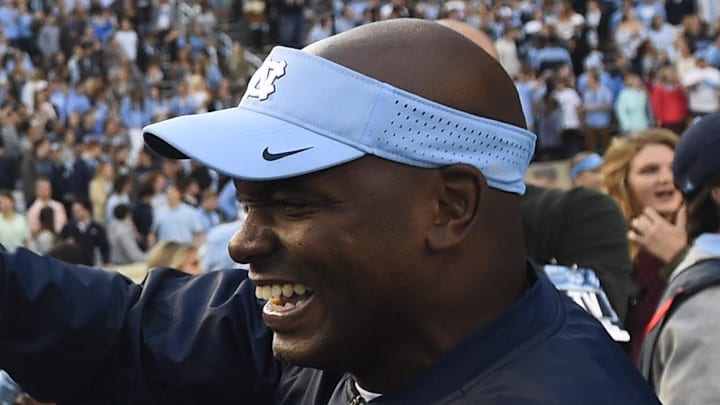 Nov 19, 2016; Chapel Hill, NC, USA; North Carolina Tar Heels safety Dominquie Green (26) reacts with defensive coach Charlton Warren on the sidelines after intercepting a pass and returning it for a touchdown in the second quarter at Kenan Memorial Stadium. Mandatory Credit: Bob Donnan-Imagn Images Nov 19, 2016; Chapel Hill, NC, USA; North Carolina Tar Heels safety Dominquie Green (26) reacts with defensive coach Charlton Warren on the sidelines after intercepting a pass and returning it for a touchdown in the second quarter at Kenan Memorial Stadium. Mandatory Credit: Bob Donnan-Imagn Images