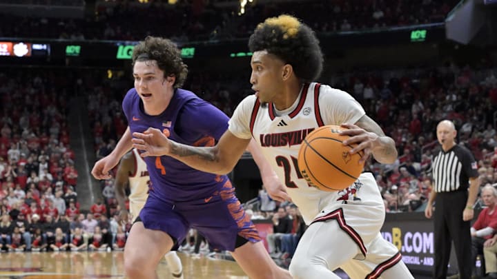 Jan 7, 2025; Louisville, Kentucky, USA; Louisville Cardinals guard Chucky Hepburn (24) dribbles against Clemson Tigers forward Ian Schieffelin (4) during the second half at KFC Yum! Center. Louisville defeated Clemson 74-64. 