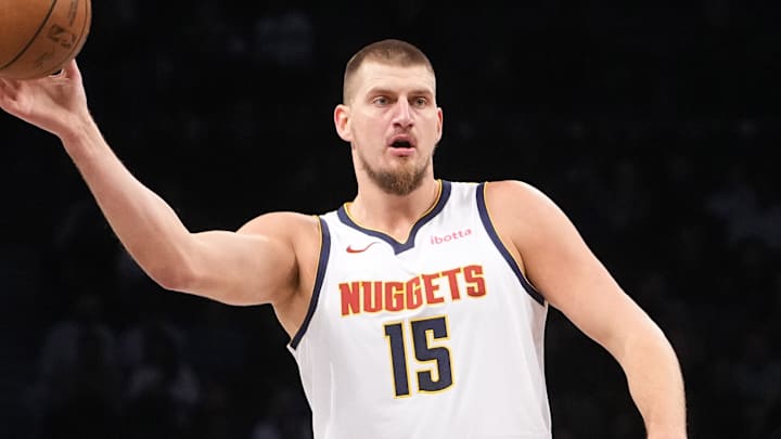 Oct 29, 2024; Brooklyn, New York, USA; Denver Nuggets center Nikola Jokic (15) passes the ball against Brooklyn Nets forward Noah Clowney (21) during the first half at Barclays Center. Mandatory Credit: Gregory Fisher-Imagn Images Oct 29, 2024; Brooklyn, New York, USA; Denver Nuggets center Nikola Jokic (15) passes the ball against Brooklyn Nets forward Noah Clowney (21) during the first half at Barclays Center. Mandatory Credit: Gregory Fisher-Imagn Images