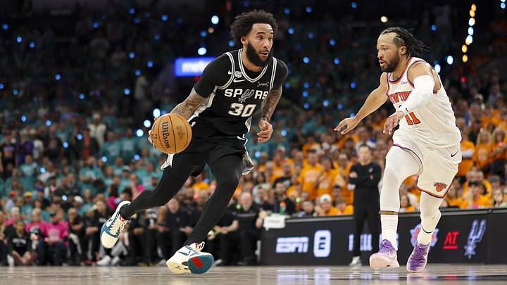 Jun 3, 2026; San Antonio, Texas, USA; San Antonio Spurs forward Julian Champagnie (30) brings the ball up court past New York Knicks guard Jalen Brunson (11) during the third quarter during Game 1 of the 2026 NBA Finals at Frost Bank Center.
