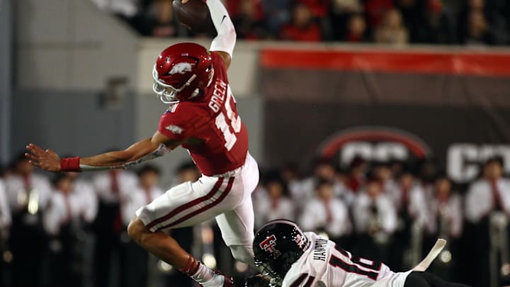 Dec 27, 2024; Memphis, TN, USA; Arkansas Razorbacks quarterback Taylen Green (10) runs the ball as Texas Tech Red Raiders defensive back Ashton Hampton (16) makes the tackle during the second quarter at Simmons Bank Liberty Stadium. Mandatory Credit: Petre Thomas-Imagn Images