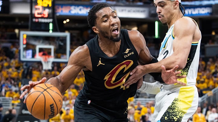 May 9, 2025; Indianapolis, Indiana, USA; Cleveland Cavaliers guard Donovan Mitchell (45) dribbles the ball while Indiana Pacers guard Andrew Nembhard (2) defends during game three of the second round for the 2025 NBA Playoffs at Gainbridge Fieldhouse. Mandatory Credit: Trevor Ruszkowski-Imagn Images