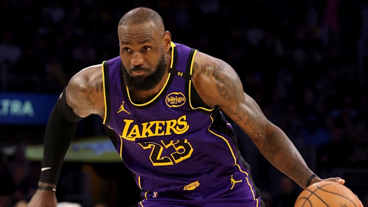 Los Angeles Lakers forward LeBron James charges down the court with the ball. Los Angeles Lakers forward LeBron James charges down the court with the ball.