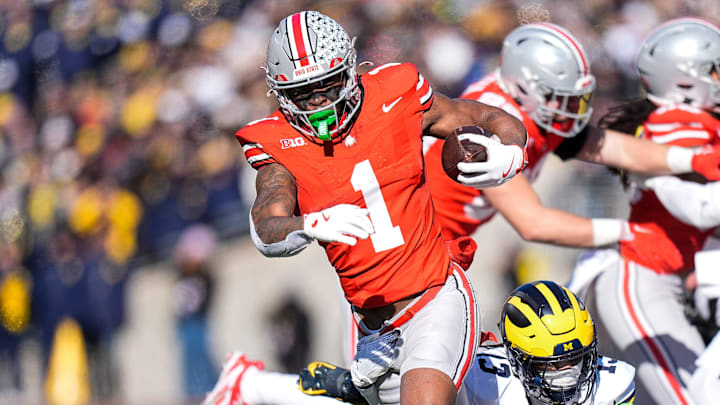 Ohio State running back Quinshon Judkins (1) runs against Michigan defensive back Wesley Walker (13) during the first half at Ohio Stadium in Columbus, Ohio on Saturday, Nov. 30, 2024.