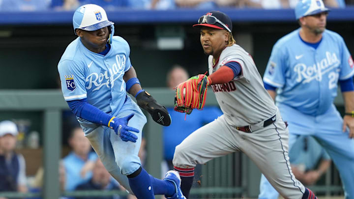 Mar 27, 2025; Kansas City, Missouri, USA; Kansas City Royals outfielder Dairon Blanco (44) is caught in a rundown by Cleveland Guardians third baseman Jose Ramirez (11) during the eighth inning at Kauffman Stadium. Mandatory Credit: Jay Biggerstaff-Imagn Images
