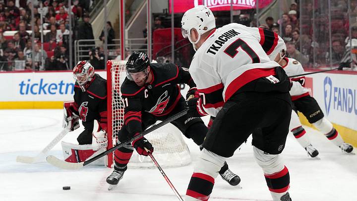 Apr 20, 2026; Raleigh, North Carolina, USA; Ottawa Senators left wing Brady Tkachuk (7) gets the shot away against Carolina Hurricanes center Jordan Staal (11) and goaltender Frederik Andersen (31) during the second period in Game 2 of the first round of the 2026 Stanley Cup Playoffs at Lenovo Center. Mandatory Credit: James Guillory-Imagn Images