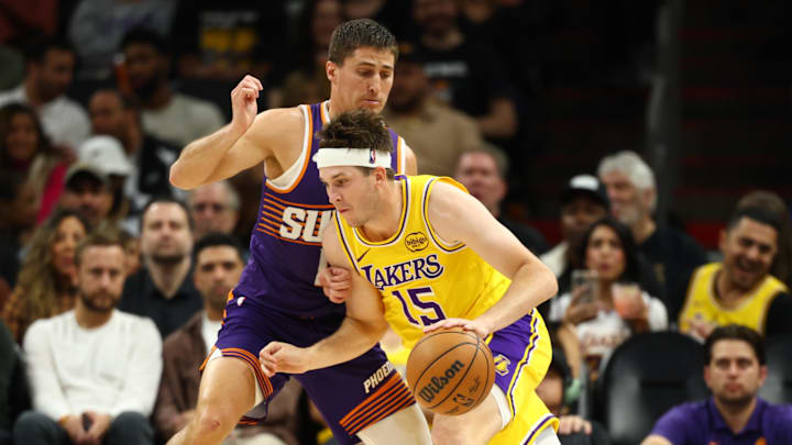 Feb 26, 2026; Phoenix, Arizona, USA; Phoenix Suns guard Collin Gillespie (12) defends against Los Angeles Lakers guard Austin Reaves (15) in the first half at Mortgage Matchup Center. Mandatory Credit: Mark J. Rebilas-Imagn Images