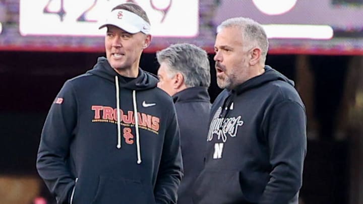 Nebraska coach Matt Rhule (right) talks with USC coach Lincoln Riley before Saturday night's game.