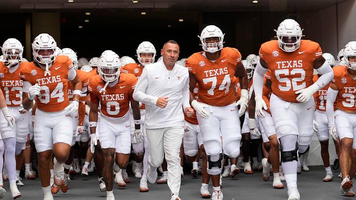 Texas Longhorns head coach Steve Sarkisian leads his team onto the field before a game against the Sam Houston State Bearkats at Darrell K Royal-Texas Memorial Stadium.