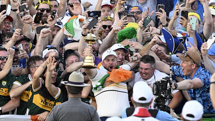 Ryder Cup clincher Shane Lowry celebrated with the trophy Sunday evening.