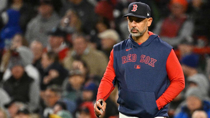 Boston Red Sox manager Alex Cora (13) walks to the mound during the sixth inning against the New York Mets at Fenway Park.