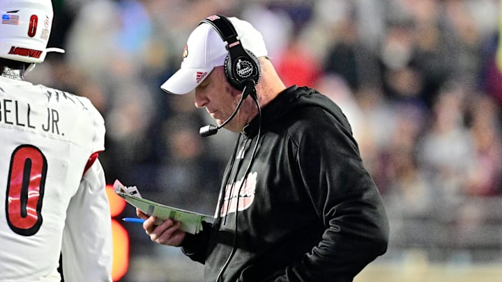 Oct 25, 2024; Chestnut Hill, Massachusetts, USA; Louisville Cardinals head coach Jeff Brohm looks over his play card during the first half against the Boston College Eagles at Alumni Stadium. Mandatory Credit: Eric Canha-Imagn Images