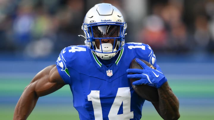 Oct 10, 2024; Seattle, Washington, USA; Seattle Seahawks wide receiver DK Metcalf (14) carries the ball after a catch during the first half against the San Francisco 49ers at Lumen Field. Mandatory Credit: Steven Bisig-Imagn Images Oct 10, 2024; Seattle, Washington, USA; Seattle Seahawks wide receiver DK Metcalf (14) carries the ball after a catch during the first half against the San Francisco 49ers at Lumen Field. Mandatory Credit: Steven Bisig-Imagn Images
